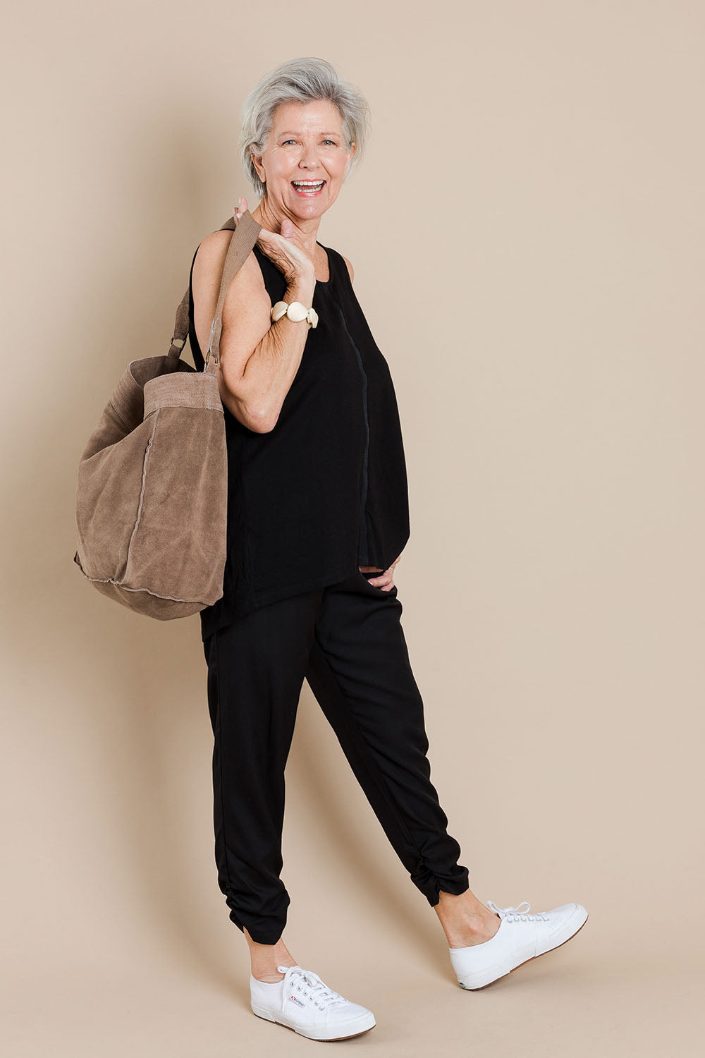 Model Elise wearing size 10 of The Best Seller Pant in colour JetBlack (Black), from the front, showing the whole outfit