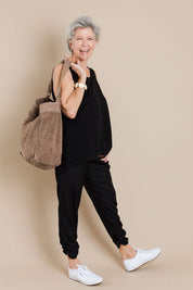 Model Elise wearing size 10 of The Best Seller Pant in colour JetBlack (Black), from the front, showing the whole outfit