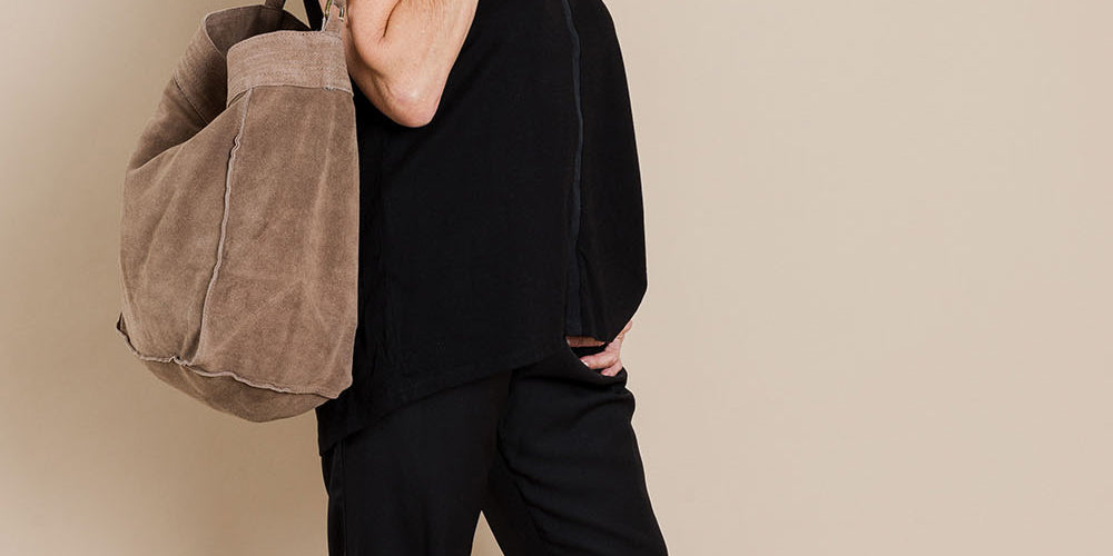 Model Elise wearing size 10 of The Best Seller Pant in colour JetBlack (Black), from the front, showing the whole outfit