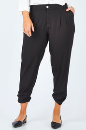 Model Laura wearing size 14 of The Best Seller Pant in colour JetBlack (Black), from the front, cropped image