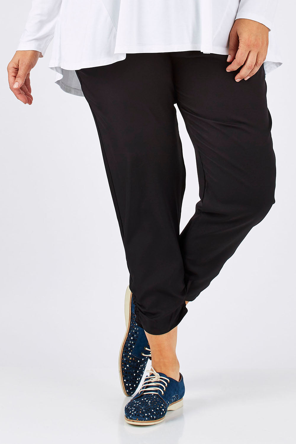 Model Ljubenka wearing size 18 of The Best Seller Pant in colour JetBlack (Black), from the front, cropped image