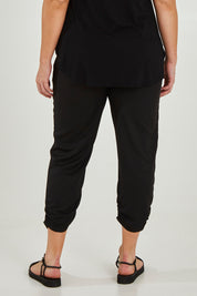 Model Maddy wearing size 16 of The Best Seller Pant in colour JetBlack (Black), from the back