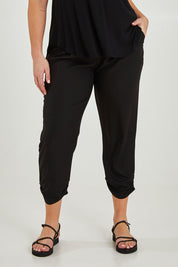 Model Maddy wearing size 16 of The Best Seller Pant in colour JetBlack (Black), from the front, cropped image