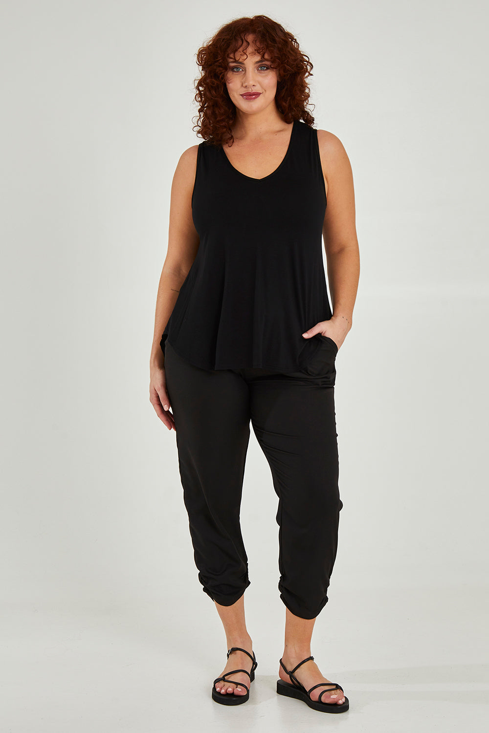 Model Maddy wearing size 16 of The Best Seller Pant in colour JetBlack (Black), from the front, showing the whole outfit