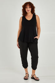 Model Maddy wearing size 16 of The Best Seller Pant in colour JetBlack (Black), from the front, showing the whole outfit