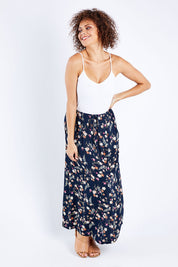 Model Lala wearing size 10 of The Drawstring Maxi Skirt in colour Fleur (Black), from the front, showing the whole outfit