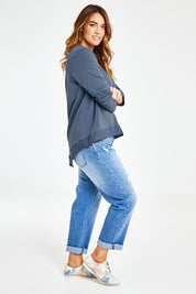 Model Laura wearing size 14 of The Hem Detail Sweater in colour Denimblue (Blue), from the front, showing the whole outfit