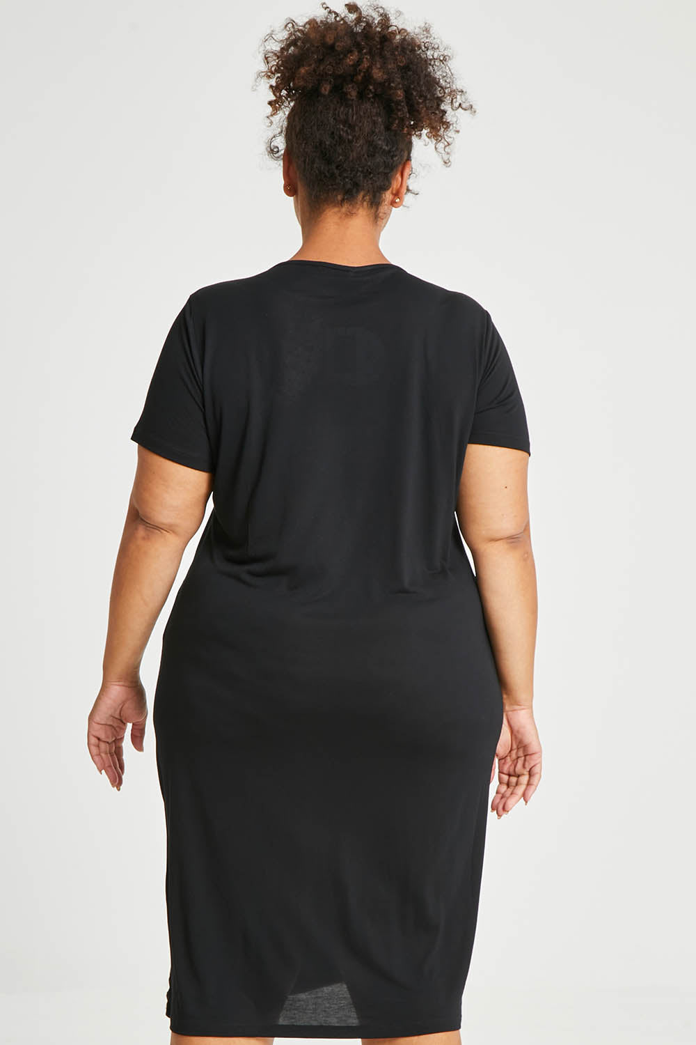 Model Alexis wearing size 16 of The Bamboo Blend Button Dress in colour Black (Black), from the back