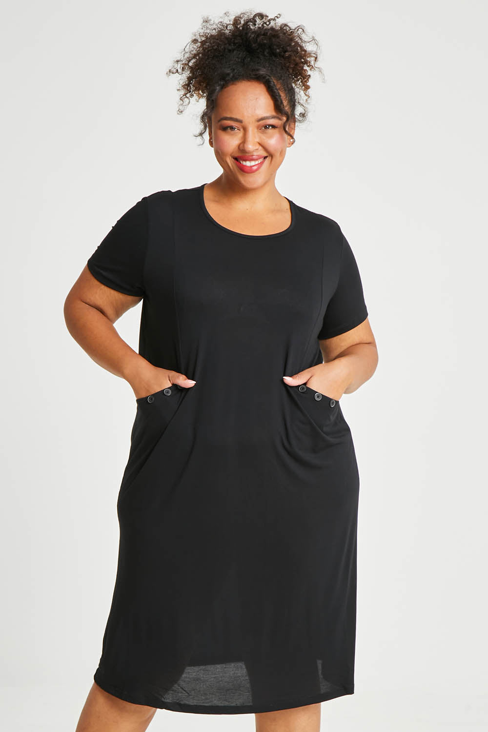 Model Alexis wearing size 16 of The Bamboo Blend Button Dress in colour Black (Black), from the front, cropped image