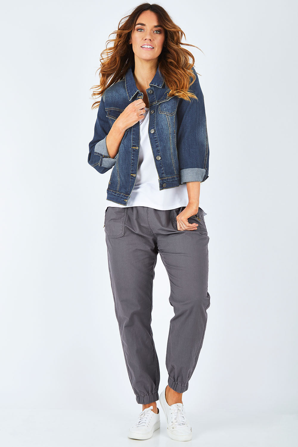 Model Laura wearing size 14 of The Denim Jacket in colour Denim (Blue), from the front, showing the whole outfit