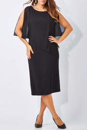 Model Laura wearing size 12 of The Overlay Midi Dress in colour Black (Black), from the front, cropped image