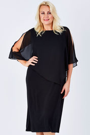 Model Natalie wearing size 16 of The Overlay Midi Dress in colour Black (Black), from the front, cropped image