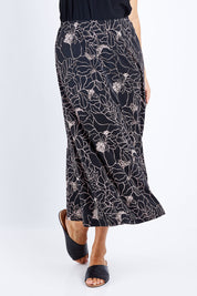 Model Lala wearing size 10 of The Pull On Skirt in colour Pinkfloral (Pink), from the front, cropped image