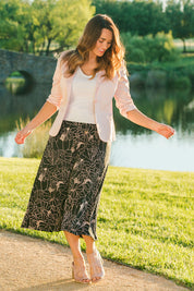 Model Laura wearing size 14 of The Pull On Skirt in colour Pinkfloral (Pink), from the front, showing the whole outfit