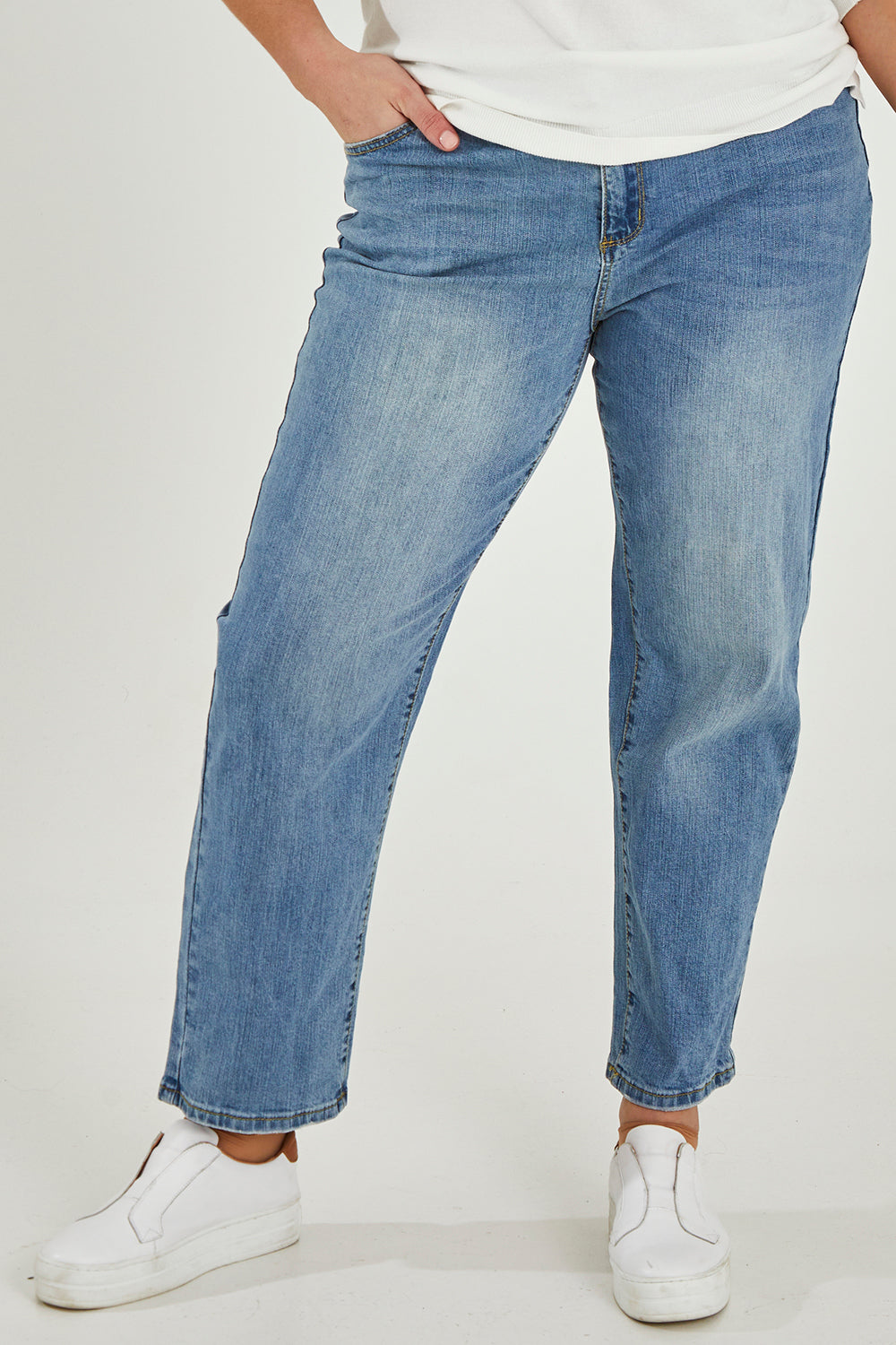 Model Maddy wearing size 16 of The Boyfriend Jean in colour Blue (Blue), from the front, cropped image
