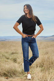 Model Amanda wearing size 10 of The Boyfriend Jean in colour Mediumblue (Blue), from the front, showing the whole outfit