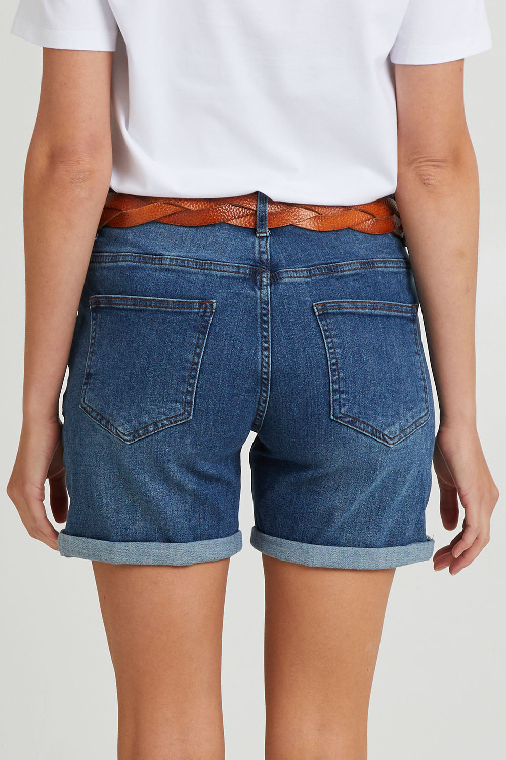 Model Madeline wearing size 10 of The 5 Pocket Denim Short in colour Dkdenim (Blue), from the back