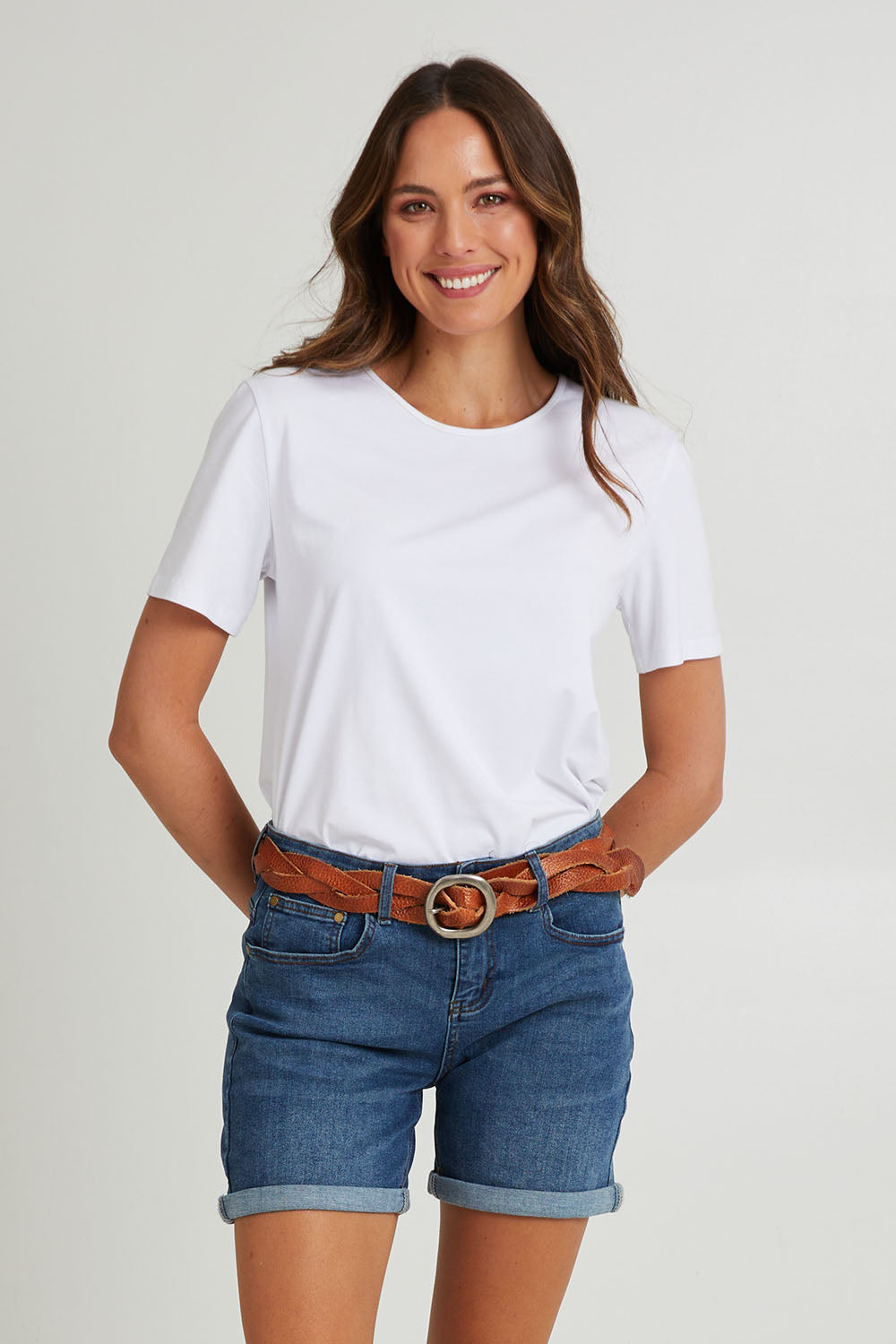 Model Madeline wearing size 10 of The 5 Pocket Denim Short in colour Dkdenim (Blue), from the front, cropped image