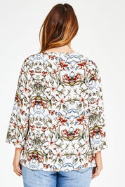 Model Laura wearing size 14 of The V Neck Printed Top in colour Peachprint (White), from the back