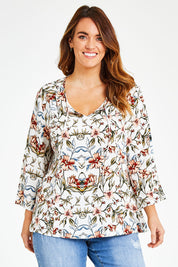 Model Laura wearing size 14 of The V Neck Printed Top in colour Peachprint (White), from the front, cropped image