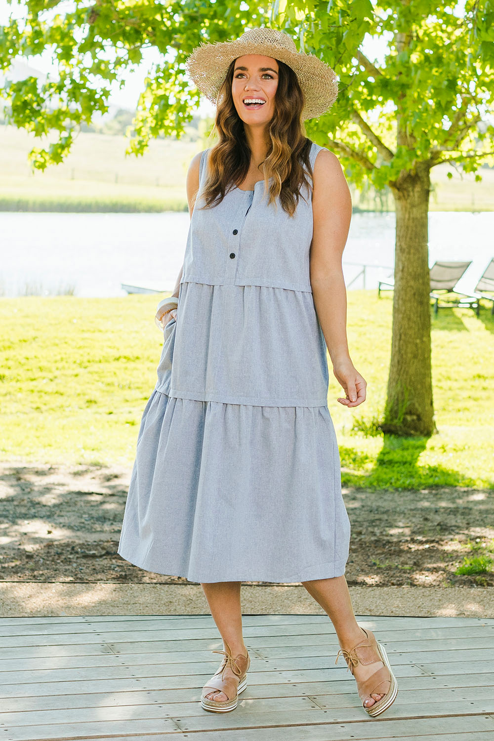 Model Laura wearing size 14 of The Chambray Tiered Dress in colour Chambray (Blue), from the front, showing the whole outfit