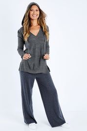 Model Kimberley wearing size S of The Hoody Knit Jumper in colour Charcoal (Grey), from the front, showing the whole outfit