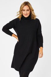 Model Jess wearing size L of The Cable Knit Dress in colour Blackfleck (Black), from the front, cropped image