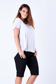 Model Laura wearing size 12 of The Pull On Short in colour Black (Black), from the front, cropped image