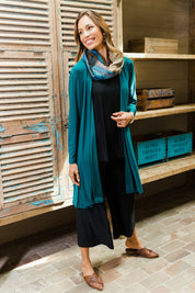 Model Amanda wearing size 10 of The Recycled Swing Cardigan in colour Deeplagoon (Green), from the front, showing the whole outfit