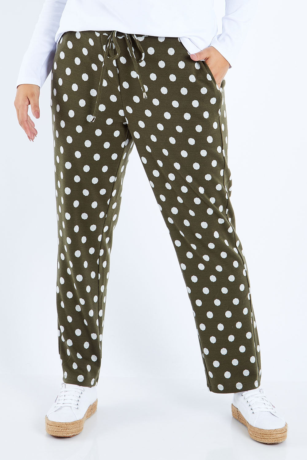 Model Sasha-Lee wearing size 16 of The Spot Jacquard Pull On Pant in colour Khakispot (Green), from the front, cropped image