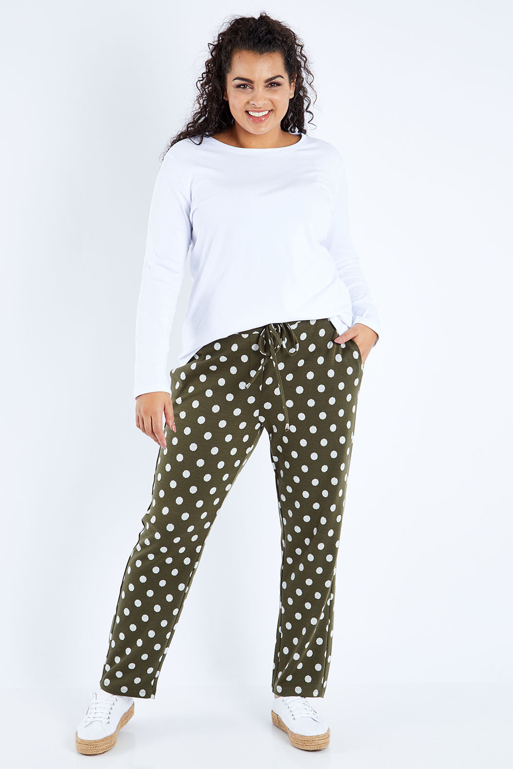 Model Sasha-Lee wearing size 16 of The Spot Jacquard Pull On Pant in colour Khakispot (Green), from the front, showing the whole outfit