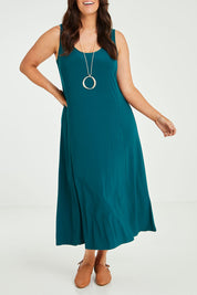Model Laura wearing size 14 of The Recycled A Line Midi Dress in colour Deeplagoon (Green), from the front, cropped image