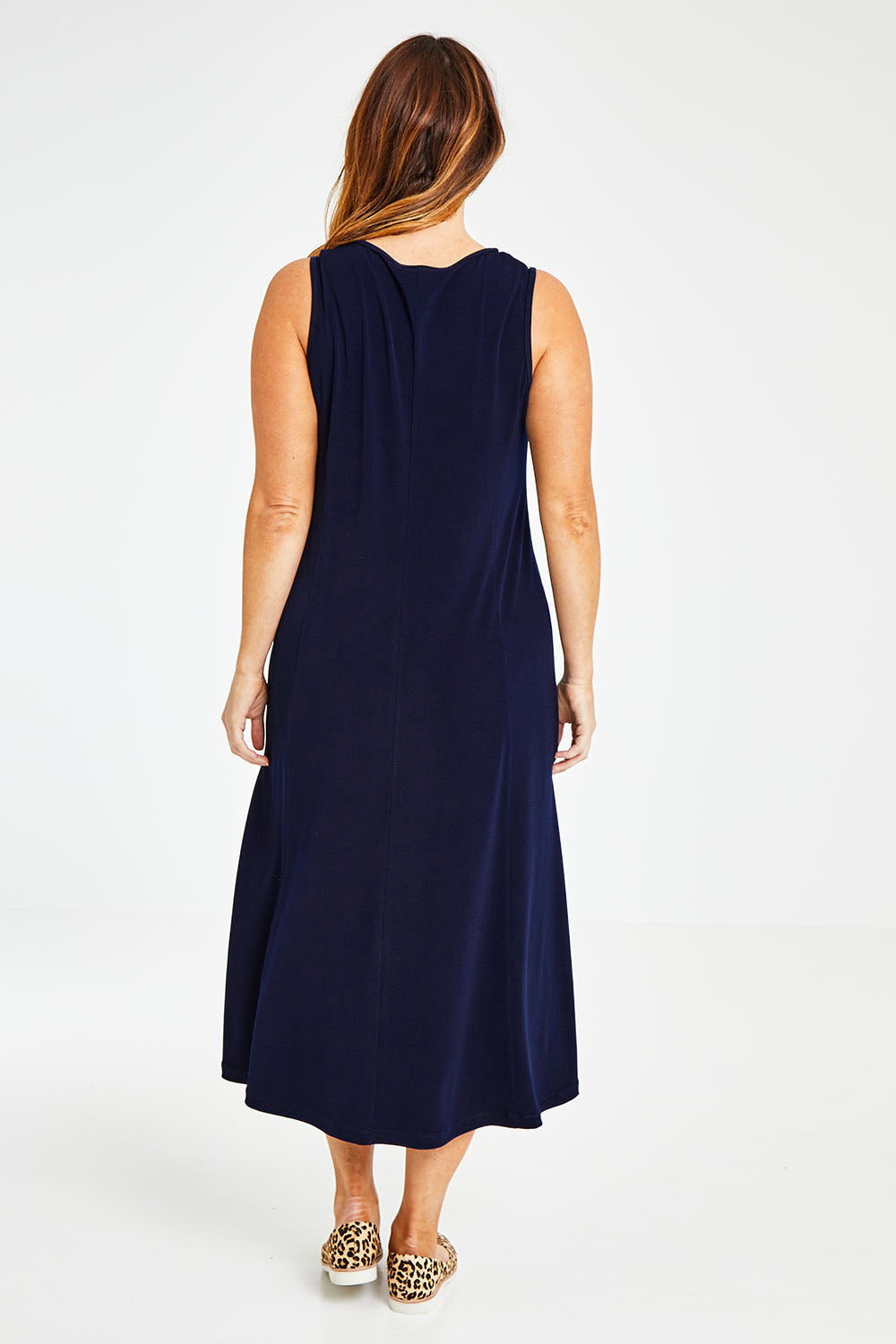 Model Laura wearing size 14 of The Recycled A Line Midi Dress in colour Navy (Blue), from the back