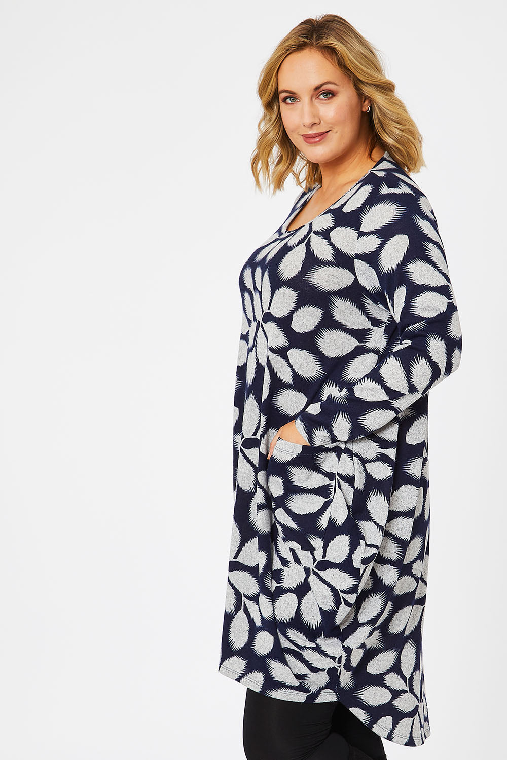 Model Jess wearing size 14 of The Cosy Pocket Detail Dress in colour Navyleaf (Blue), from the front, cropped image