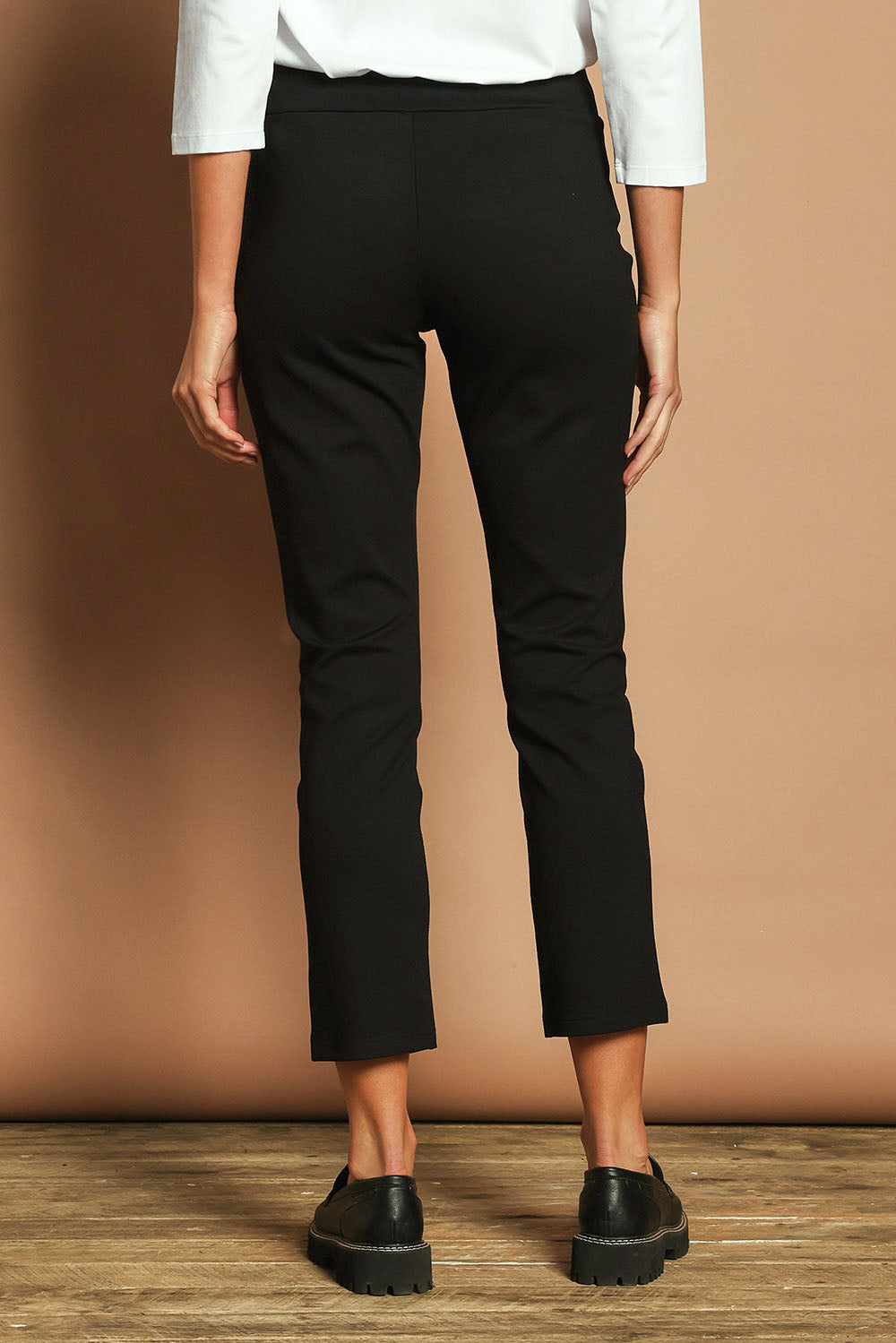 Model Madeline wearing size 10 of The Straight Leg Ponte Pant in colour Black (Black), from the back