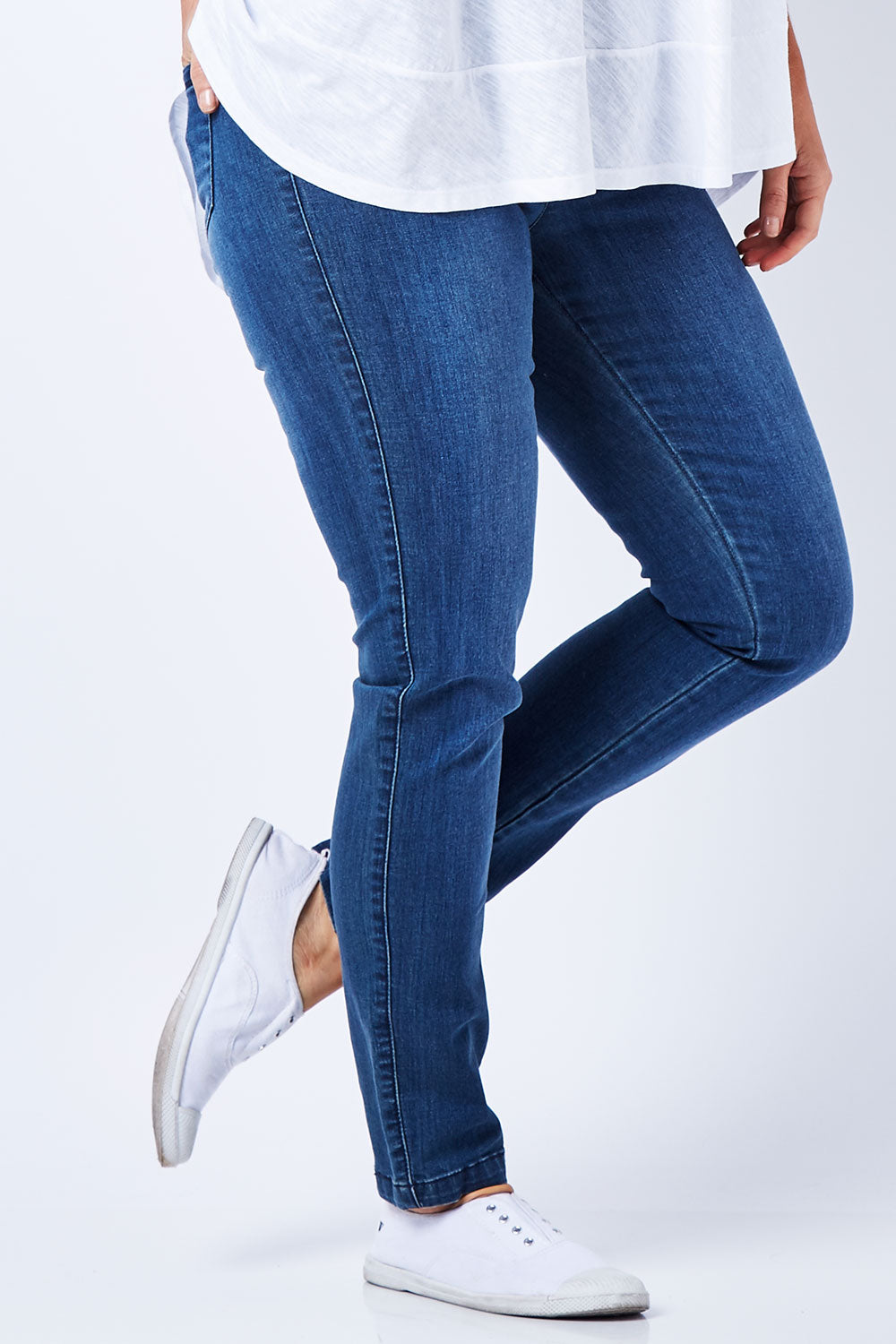 Model Laura wearing size 12 of The Everyday Jegging in colour Denim (Blue), from the front, cropped image