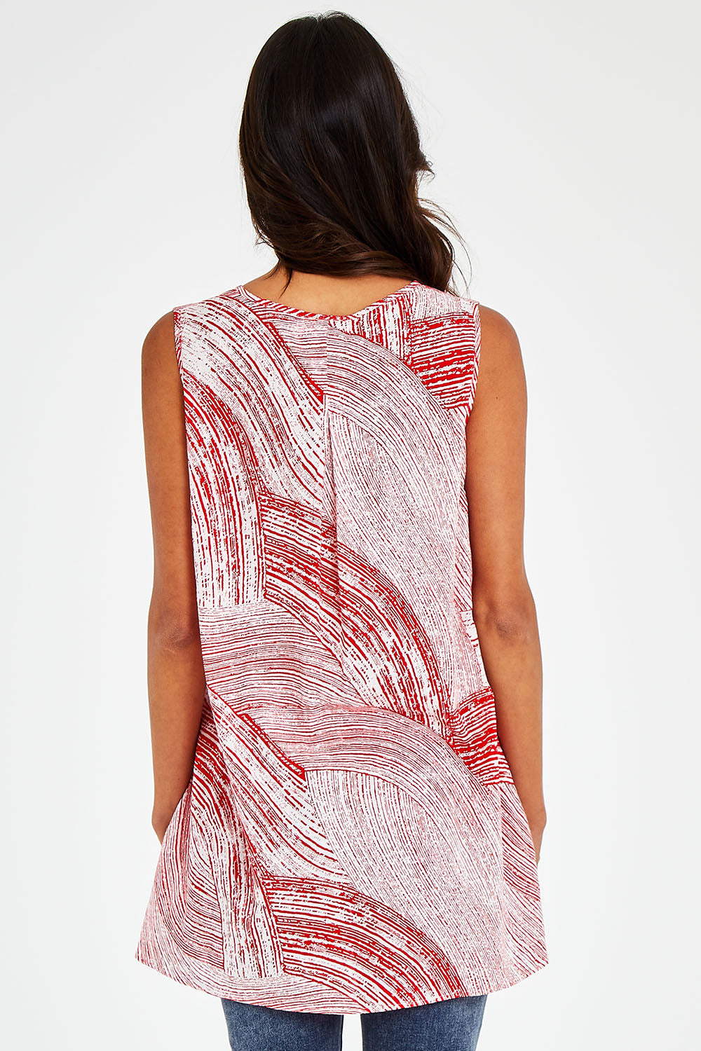Model Vitoria wearing size 10 of The Trapeze Print Top in colour Redwhite (Red), from the back