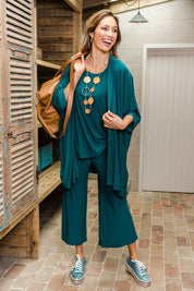 Model Amanda wearing size 10 of The Recycled Relax Fit Pant in colour Deeplagoon (Green), from the front, showing the whole outfit