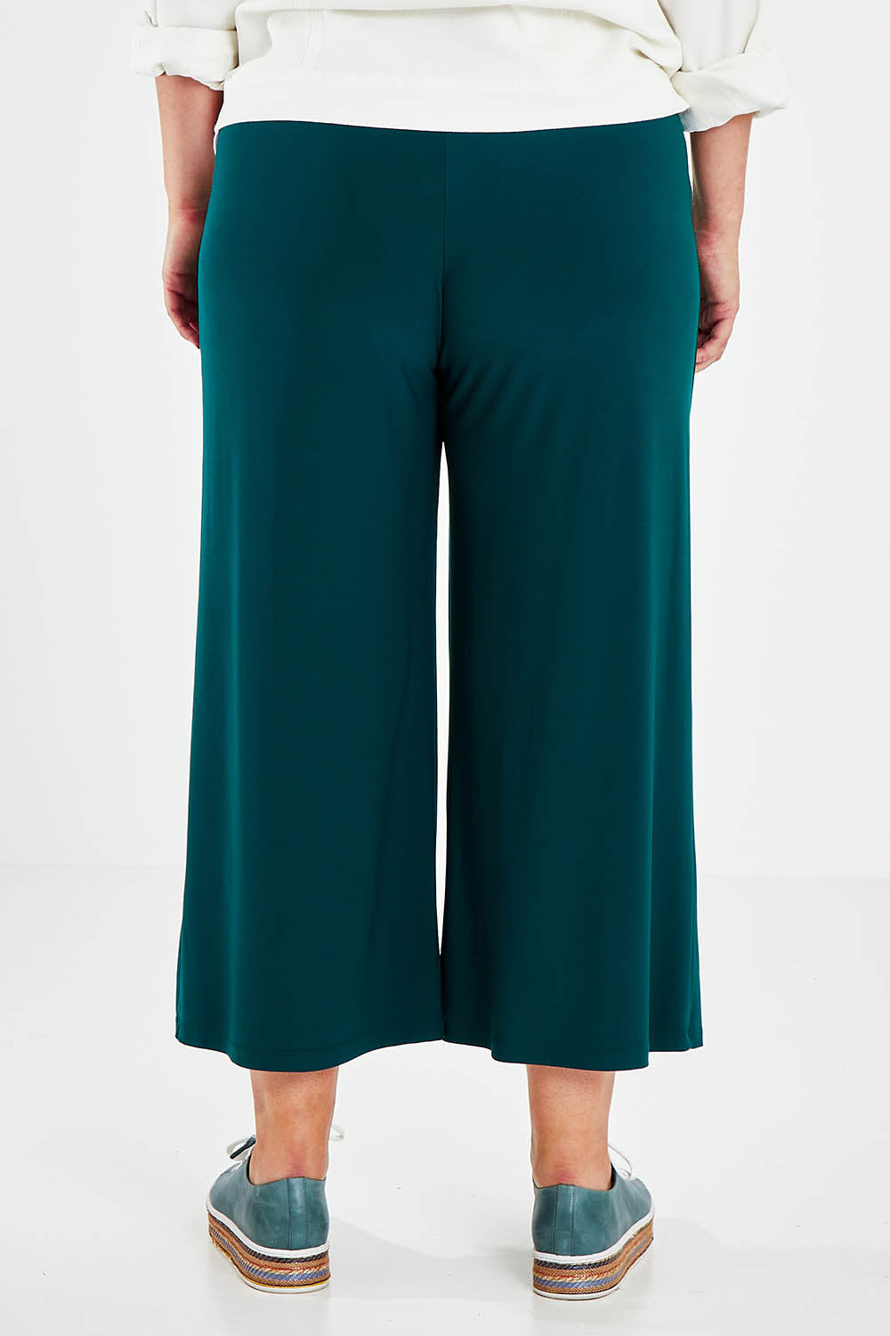 Model Jess wearing size 14 of The Recycled Relax Fit Pant in colour Deeplagoon (Green), from the back
