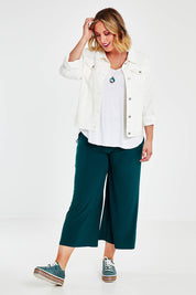 Model Jess wearing size 14 of The Recycled Relax Fit Pant in colour Deeplagoon (Green), from the front, showing the whole outfit