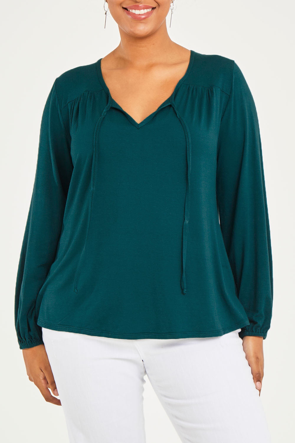 Model Terri-Leigh wearing size 14 of the Preloved The V Neck Tie Top in colour Juniper (Green), from the front, cropped image