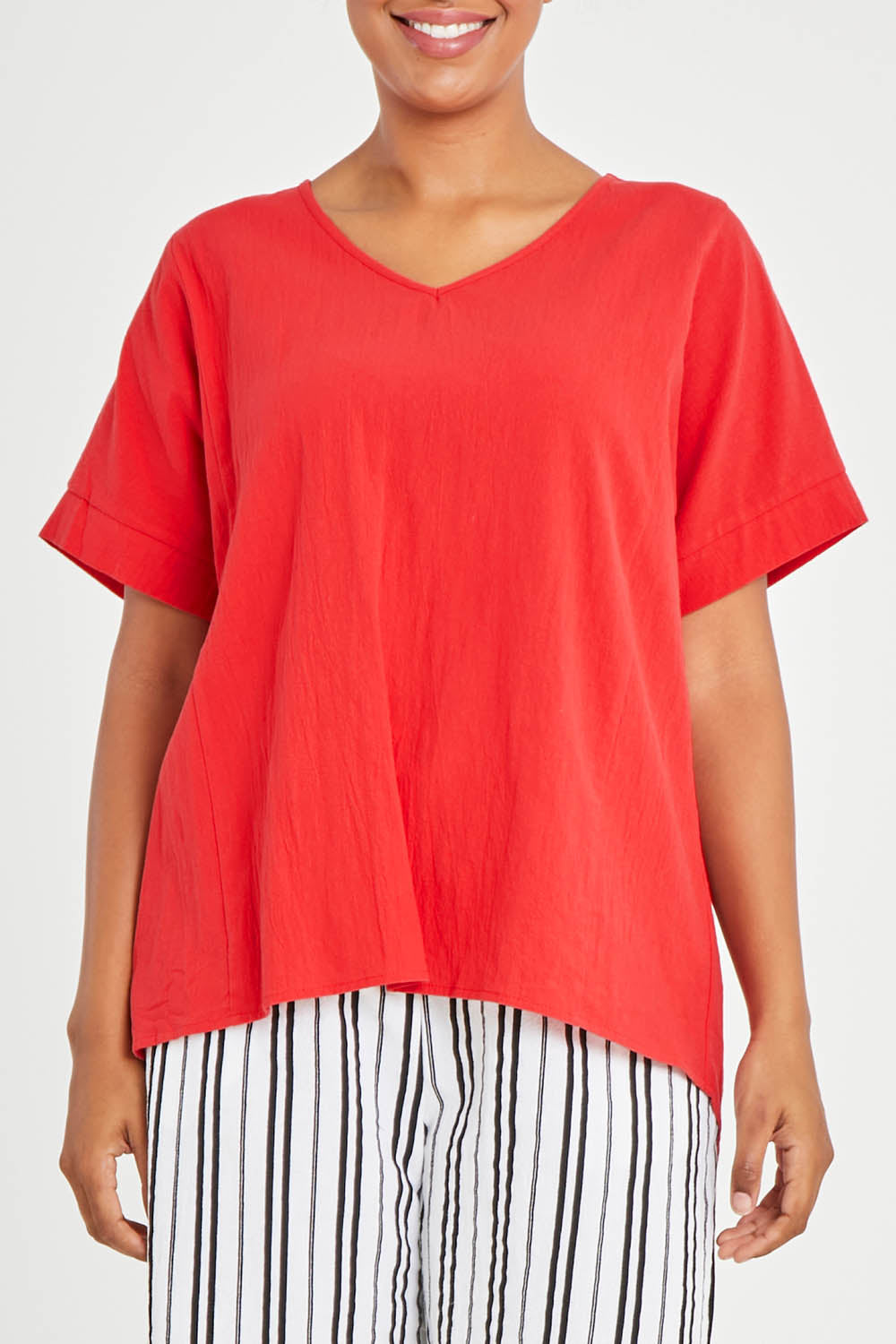 Model Noli wearing size 14 of The Relaxed Fit Woven Tee in colour Red (Red), from the front, cropped image