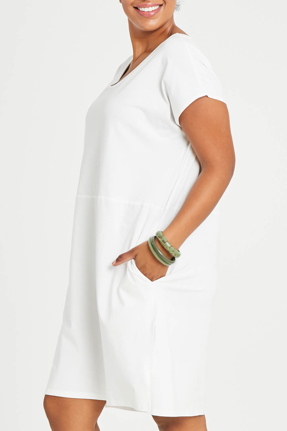 Model Noli wearing size 14 of The Luxe Cotton Tee Dress in colour White (White), from the front, cropped image