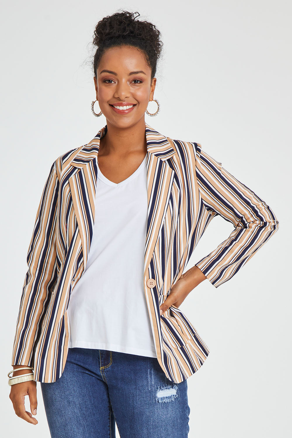 Model Noli wearing size 14 of The Striped Boyfriend Blazer in colour Camelstrip, from the front, cropped image
