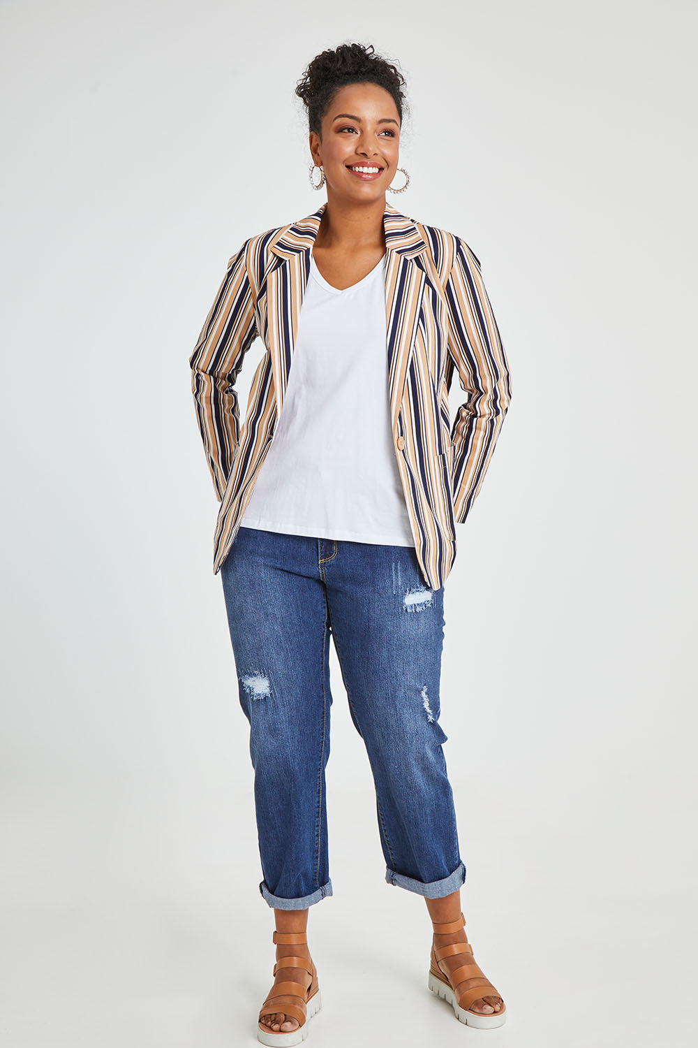 Model Noli wearing size 14 of The Striped Boyfriend Blazer in colour Camelstrip, from the front, showing the whole outfit