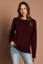 Model Madeline wearing size M of The Keepers Soft Round Neck Jumper in colour Firered (Red), from the front, showing the whole outfit