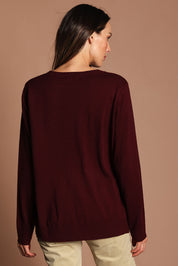 Model Madeline wearing size S of The Keepers Soft Round Neck Jumper in colour Firered (Red), from the back