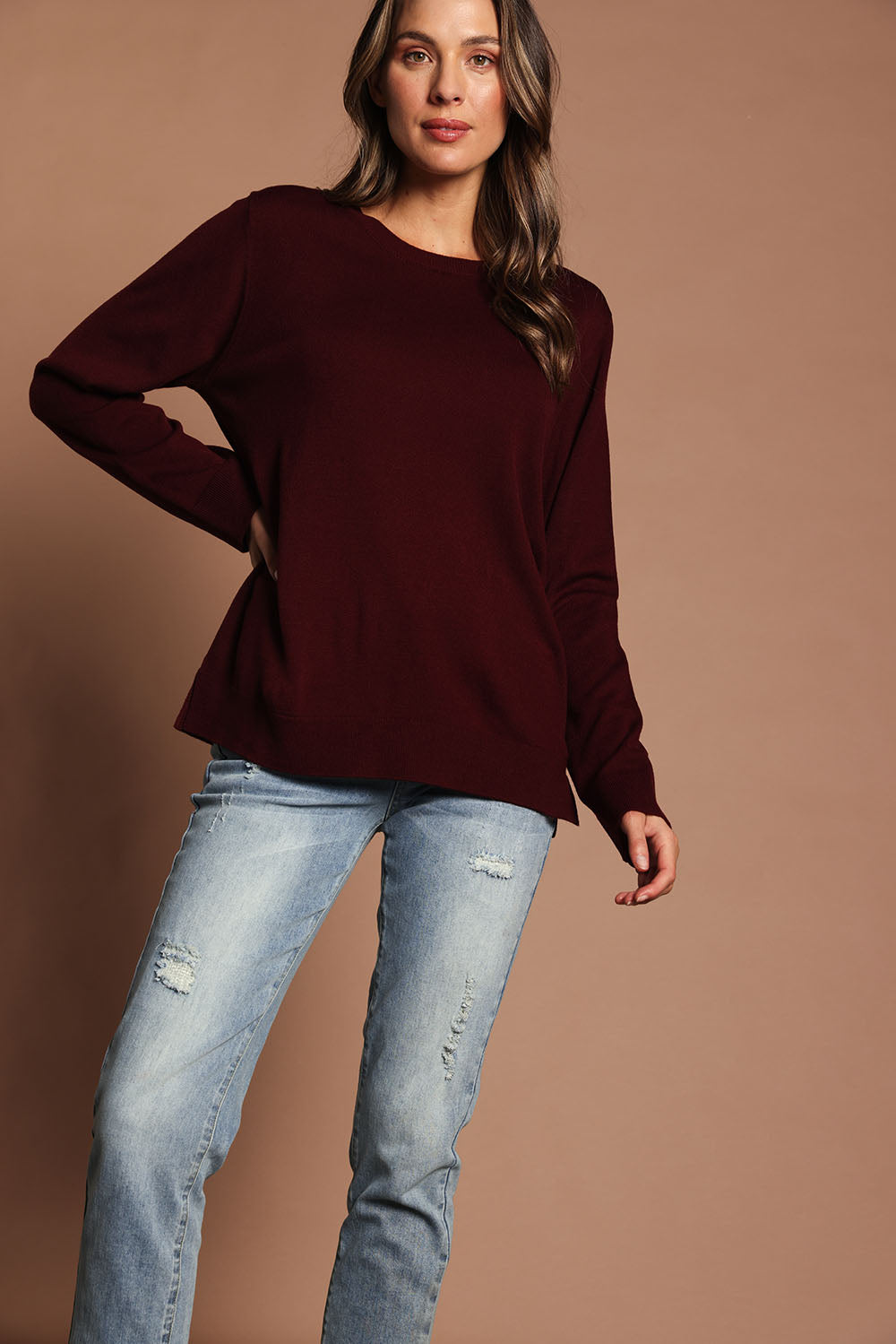 Model Madeline wearing size S of The Keepers Soft Round Neck Jumper in colour Firered (Red), from the front, showing the whole outfit