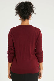 Model Noli wearing size L of The Keepers Soft Round Neck Jumper in colour Firered (Red), from the back