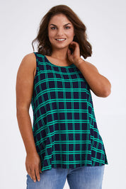 Model Monique wearing size 14 of The Printed Drape Tank in colour Navycheck (Blue), from the front, cropped image